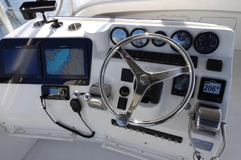 Slide: The Image of Control panel of a 2001 Luhrs 36 Convertible boat with navigation instruments. - 16