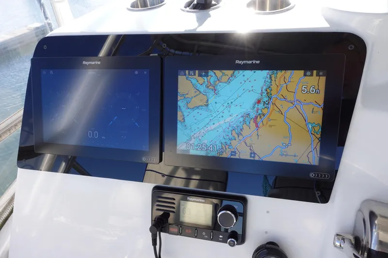 Slide: The Image of Control panel of a 2001 Luhrs 36 Convertible with dual Raymarine displays. - 17