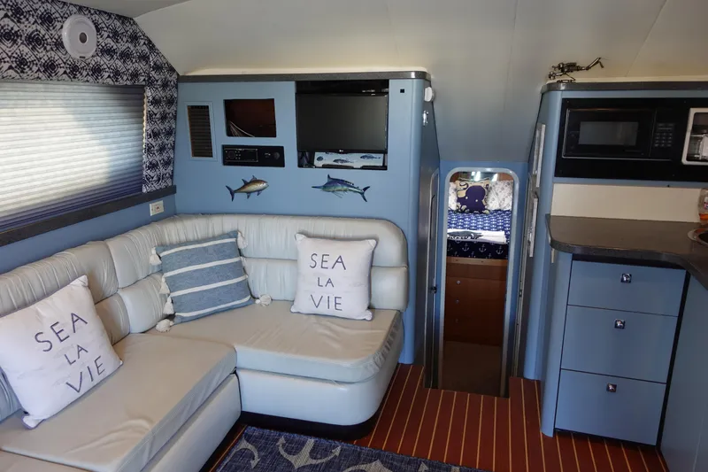 Slide: The Image of Interior of 2001 Luhrs 36 Convertible yacht with cozy seating and nautical decor. - 21