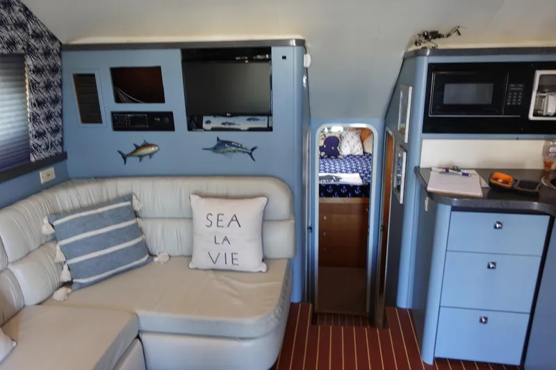 Slide: The Image of Interior of 2001 Luhrs 36 Convertible yacht with cozy seating and nautical decor. - 25