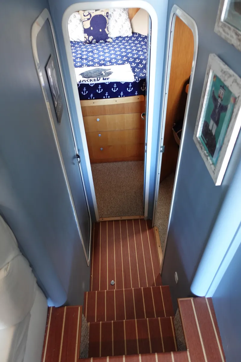 Slide: The Image of Interior of 2001 Luhrs 36 Convertible yacht, featuring stairs and a cozy bedroom. - 26