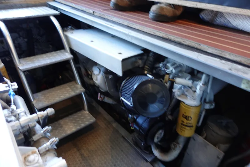 Slide: The Image of Engine room of 2001 Luhrs 36 Convertible boat, showing machinery and access stairs. - 32