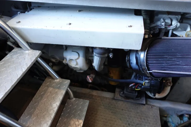 Slide: The Image of Engine compartment of 2001 Luhrs 36 Convertible boat with visible components and metal steps. - 33