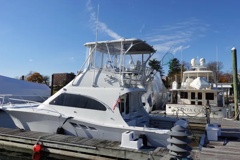 Slide: The Image of 2001 Luhrs 36 Convertible yacht docked at marina under clear blue sky. - 4