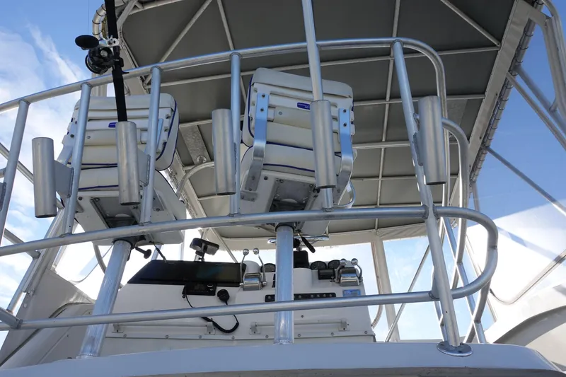 Slide: The Image of 2001 Luhrs 36 Convertible boat helm with dual captain chairs and control panel. - 6