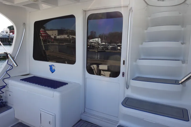 Slide: The Image of 2001 Luhrs 36 Convertible boat deck with stairs and seating area. - 9