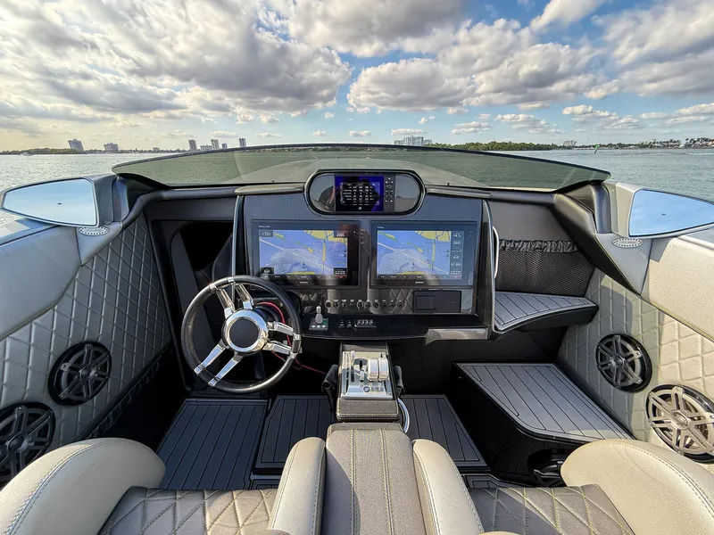 Slide: The Image of 2017 Nor-Tech 3900 Super-VEE cockpit with dual navigation screens and luxury seating. - 13