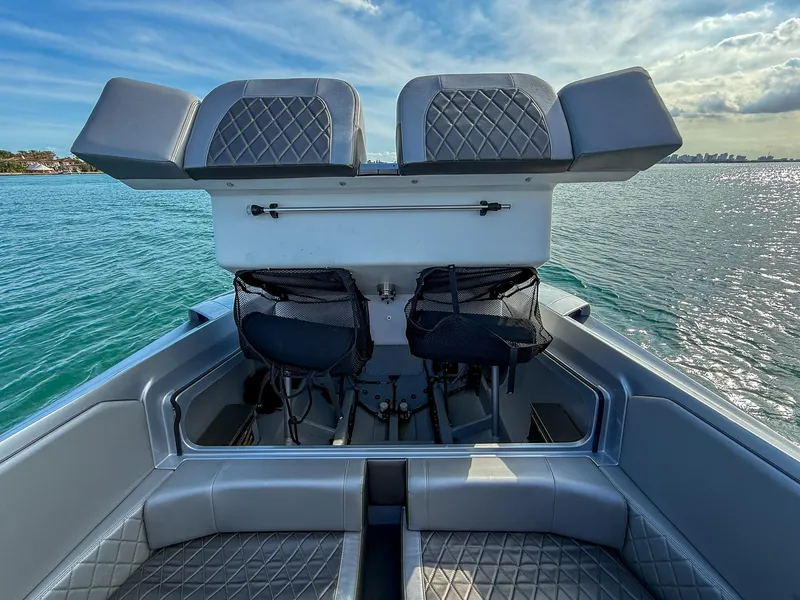 Slide: The Image of 2017 Nor-Tech 3900 Super-VEE boat interior with diamond-stitched seats on a sunny day. - 19