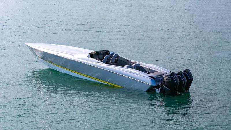 Slide: The Image of 2017 Nor-Tech 3900 Super-VEE speedboat on calm water, featuring multiple outboard engines. - 2