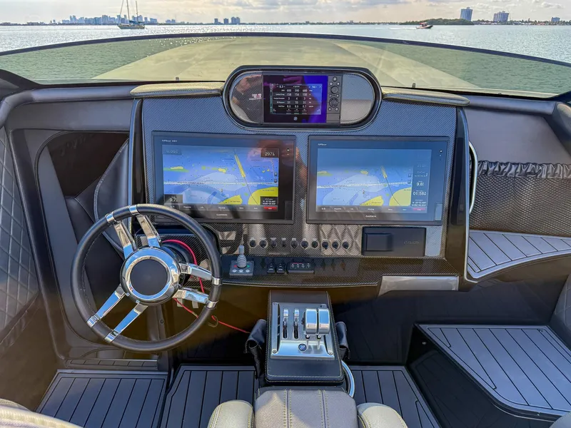 Slide: The Image of 2017 Nor-Tech 3900 Super-VEE cockpit with dual navigation screens and modern steering wheel. - 21