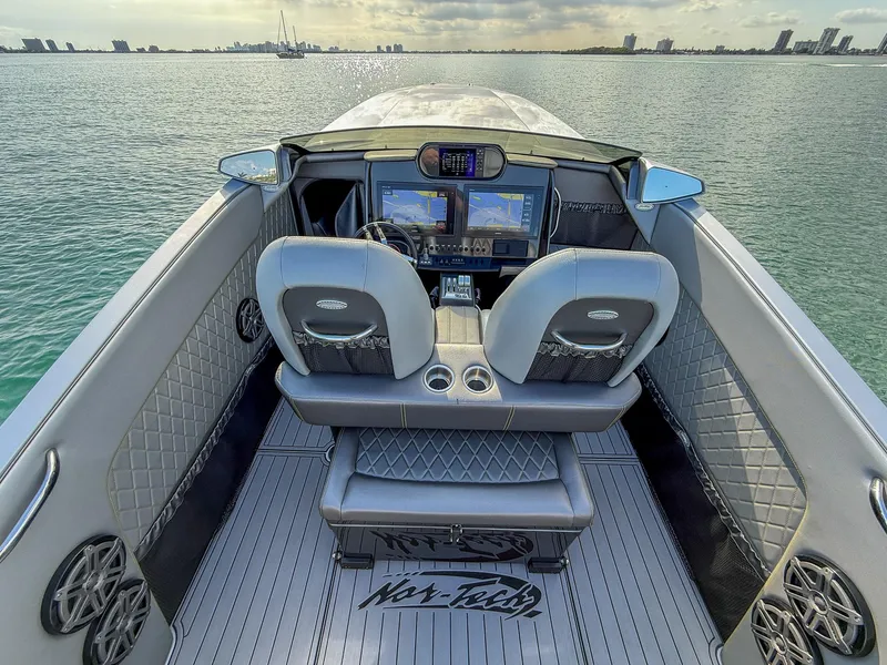 Slide: The Image of 2017 Nor-Tech 3900 Super-VEE boat interior with dual seats and navigation screens. - 23