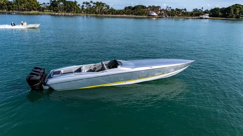 Slide: The Image of 2017 Nor-Tech 3900 Super-VEE speedboat on calm water, with scenic background. - 27