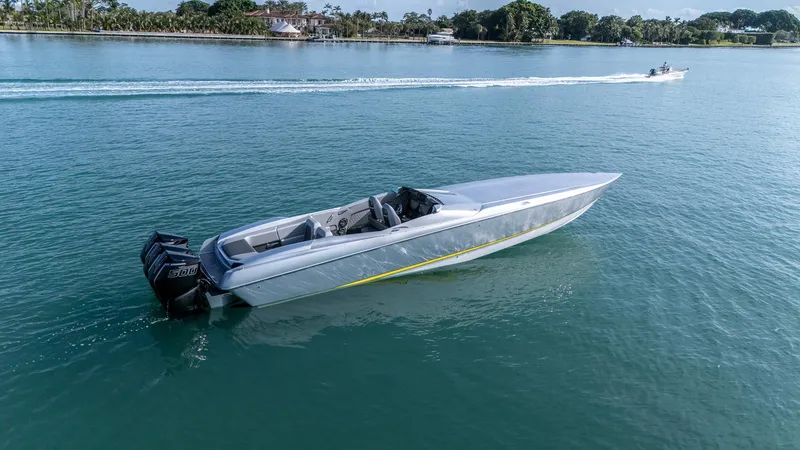 Slide: The Image of 2017 Nor-Tech 3900 Super-VEE speedboat on calm water, showcasing sleek design and powerful engines. - 28