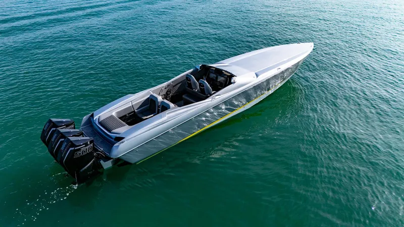 Slide: The Image of 2017 Nor-Tech 3900 Super-VEE speedboat on clear water, featuring powerful outboard engines. - 29
