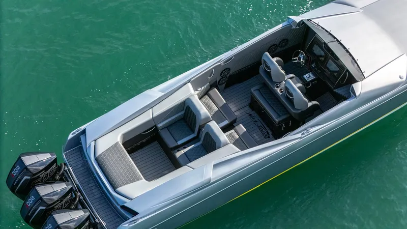Slide: The Image of 2017 Nor-Tech 3900 Super-VEE boat with triple outboard engines on turquoise water. - 3