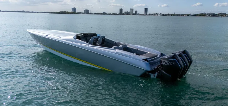 Slide: The Image of 2017 Nor-Tech 3900 Super-VEE speedboat on calm water with city skyline background. - 32