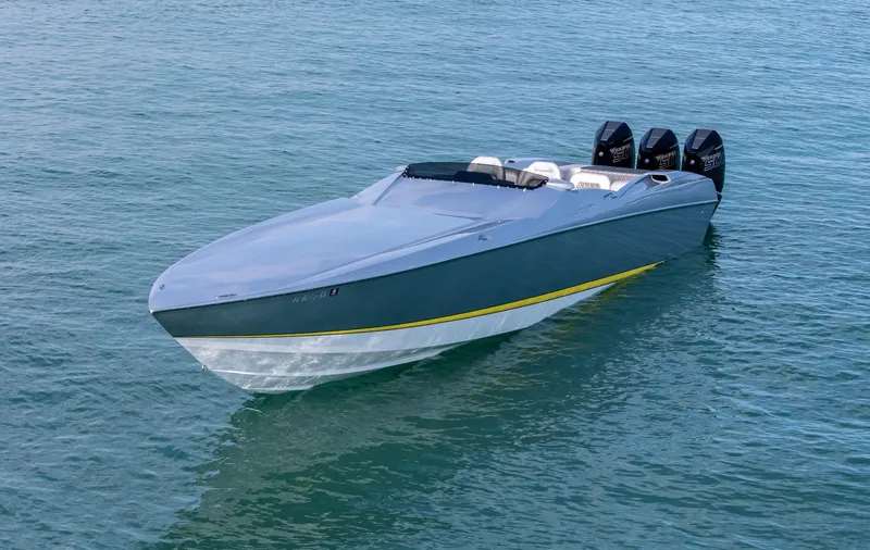 Slide: The Image of 2017 Nor-Tech 3900 Super-VEE speedboat on calm water with triple outboard engines. - 34