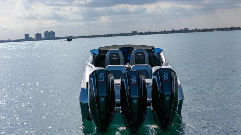 Slide: The Image of 2017 Nor-Tech 3900 Super-VEE boat with triple outboard engines on calm water. - 48