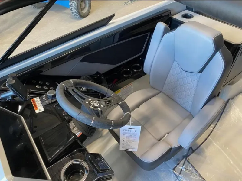 Slide: The Image of Interior of 2024 Yamaha Boats 255XE, featuring sleek steering and modern seating. - 6