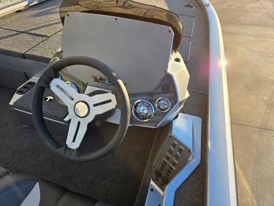 Slide: The Image of 2025 Vexus AVX1880 boat dashboard with steering wheel and control panel. - 6