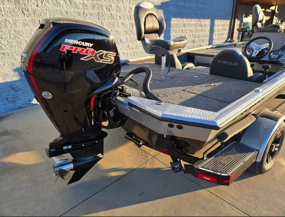 Slide: The Image of 2025 Vexus AVX1880 boat with Mercury Pro XS engine, parked on a trailer. - 7