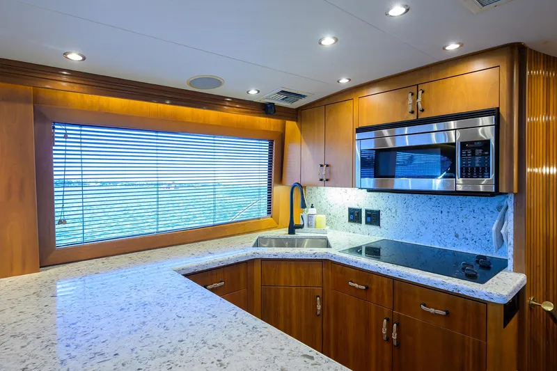 Slide: The Image of Luxurious kitchen interior of 2001 Hatteras 60 Convertible yacht with modern appliances. - 14