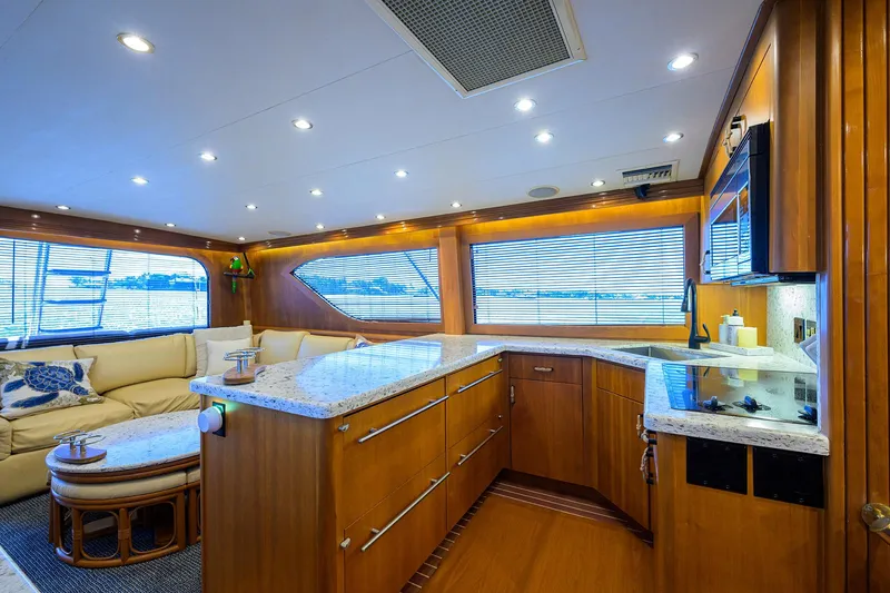 Slide: The Image of Luxurious interior of 2001 Hatteras 60 Convertible yacht with modern kitchen and seating area. - 15