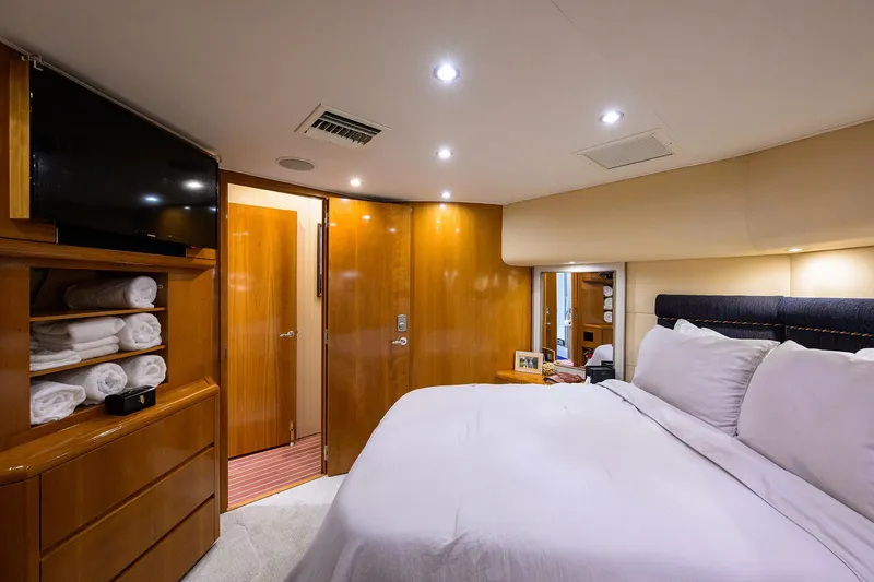 Slide: The Image of Luxurious bedroom interior of 2001 Hatteras 60 Convertible yacht with modern amenities. - 22