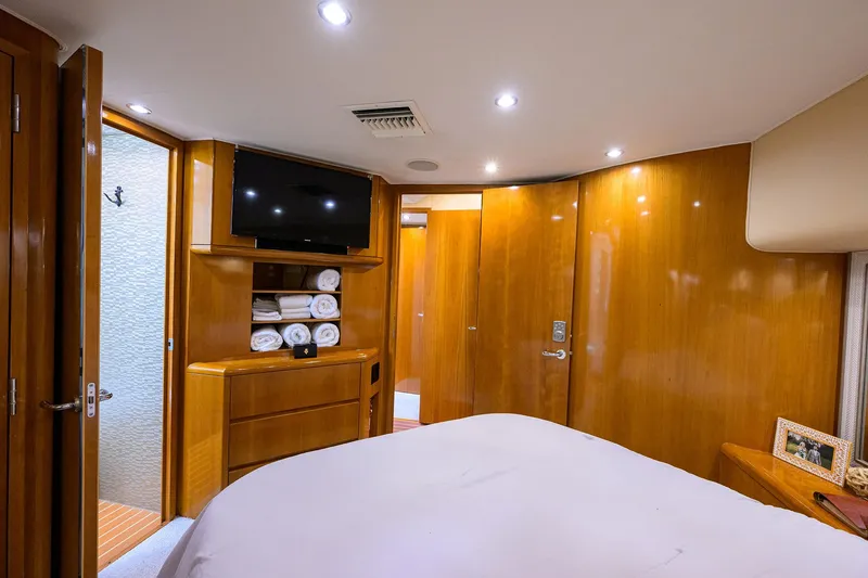 Slide: The Image of Luxurious cabin interior of 2001 Hatteras 60 Convertible yacht with wood paneling and modern amenities. - 23