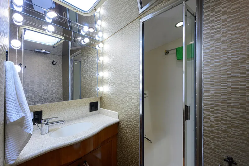 Slide: The Image of Luxurious bathroom in 2001 Hatteras 60 Convertible yacht with modern fixtures and lighting. - 25