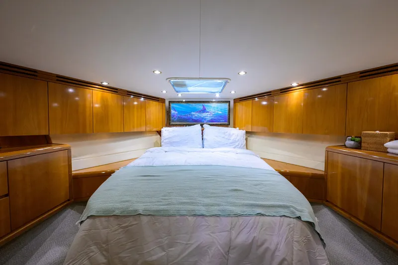 Slide: The Image of Luxurious cabin interior of 2001 Hatteras 60 Convertible yacht with cozy bed. - 28