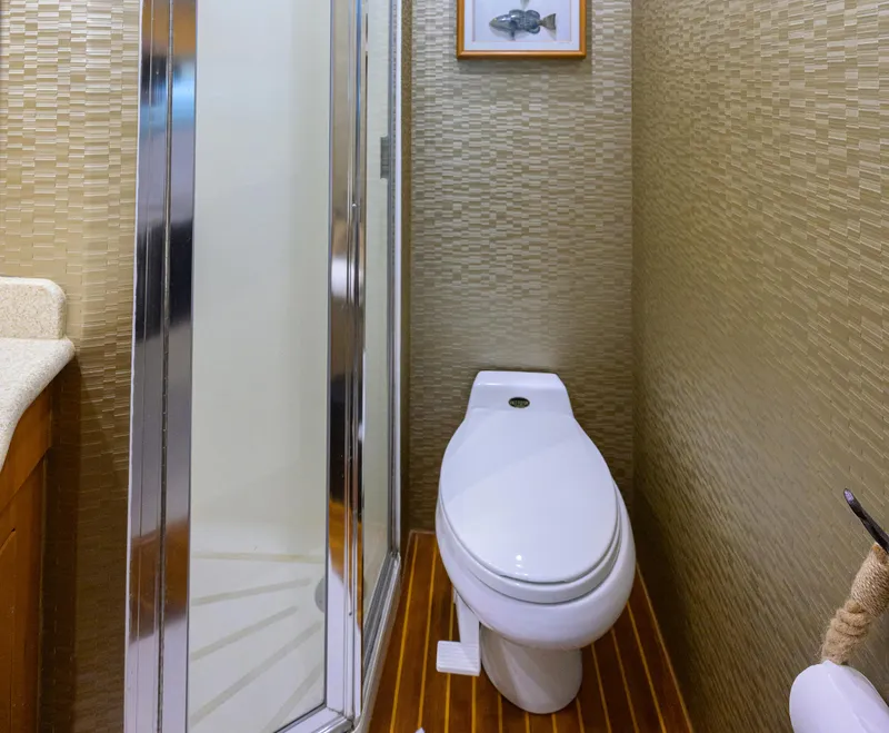 Slide: The Image of Bathroom interior of 2001 Hatteras 60 Convertible yacht with shower and toilet. - 31
