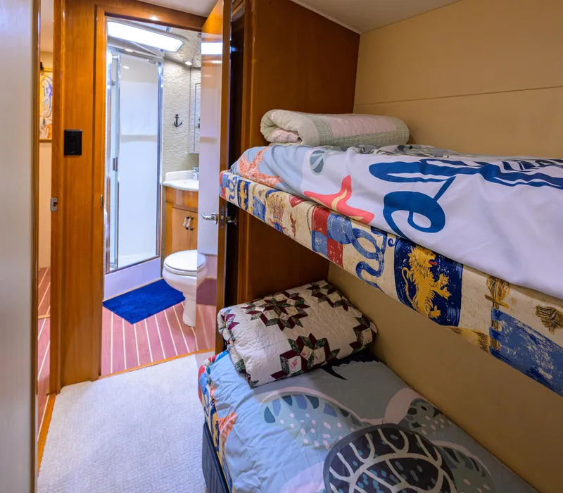 Slide: The Image of Cozy cabin with bunk beds and bathroom in 2001 Hatteras 60 Convertible yacht. - 36