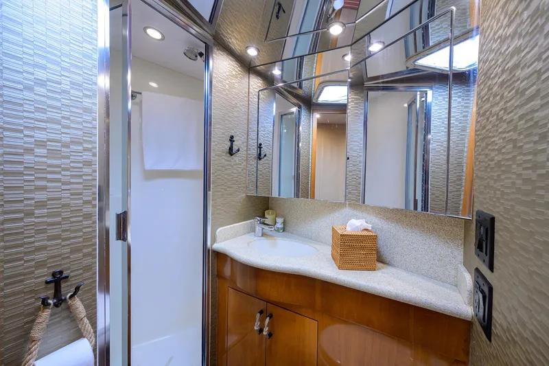 Slide: The Image of Luxurious bathroom in 2001 Hatteras 60 Convertible yacht with modern fixtures and elegant design. - 38
