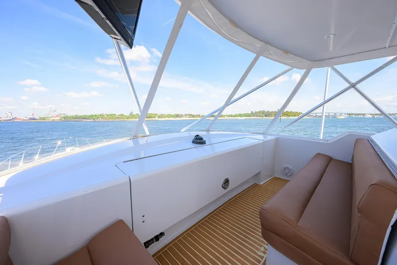 Slide: The Image of Interior view of 2001 Hatteras 60 Convertible yacht with brown seating and ocean backdrop. - 45