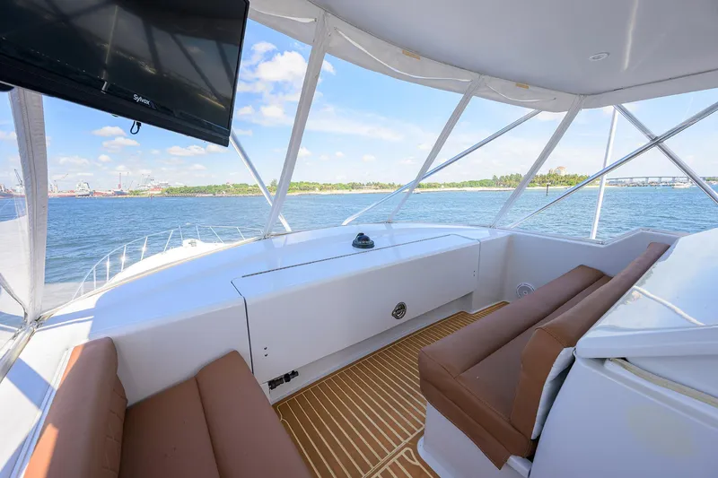 Slide: The Image of Interior view of 2001 Hatteras 60 Convertible yacht with seating and ocean backdrop. - 46