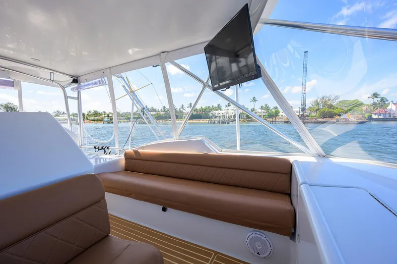 Slide: The Image of Interior of 2001 Hatteras 60 Convertible yacht with brown seating and waterfront view. - 47