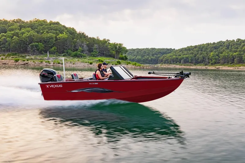 The Image of 2025 Vexus ADX180 LS boat speeding on a scenic lake. - 1