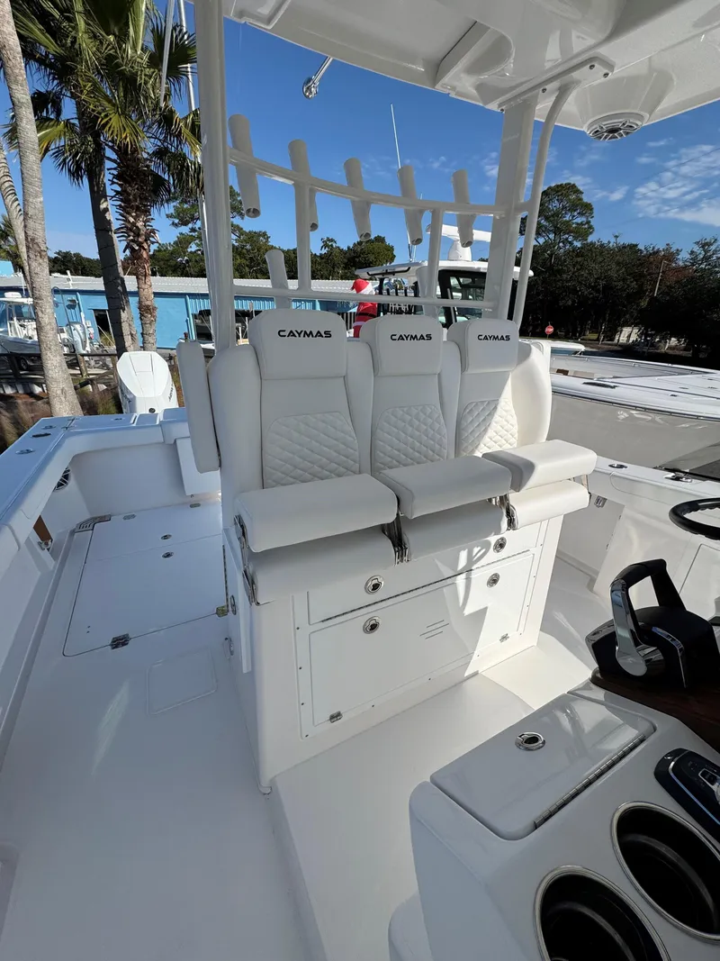 Slide: The Image of 2025 Caymas 34 CT boat interior with white seating and helm station. - 14
