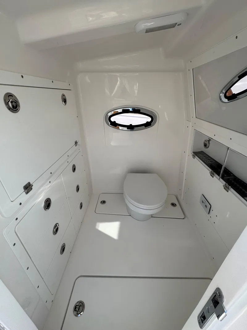 Slide: The Image of 2025 Caymas 34 CT boat bathroom with modern fixtures and porthole window. - 16