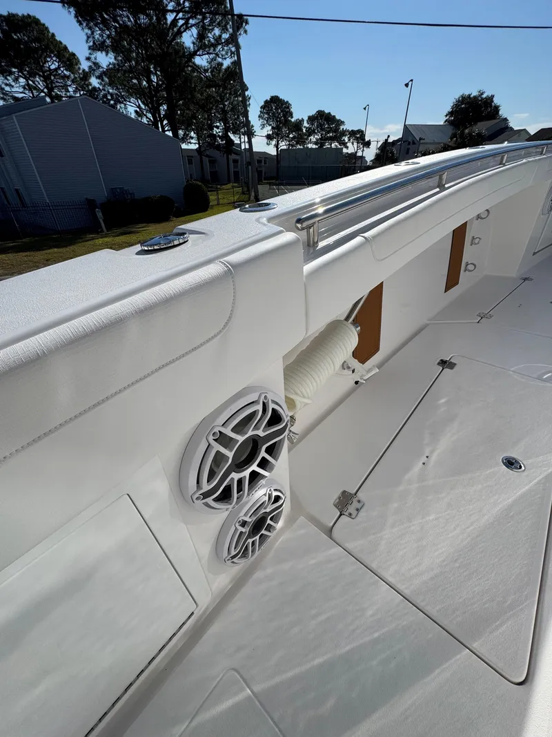 Slide: The Image of 2025 Caymas 34 CT boat deck with speakers and storage compartments. - 18