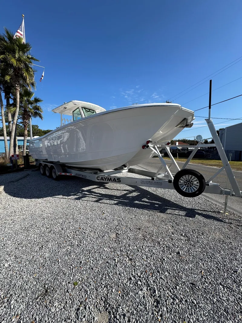 Slide: The Image of 2025 Caymas 34 CT boat on trailer under clear blue sky. - 2
