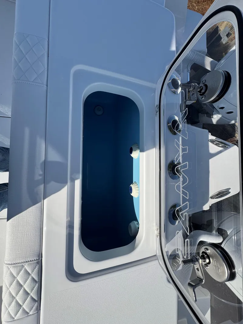 Slide: The Image of 2025 Caymas 34 CT boat livewell with open lid, showcasing interior features. - 23