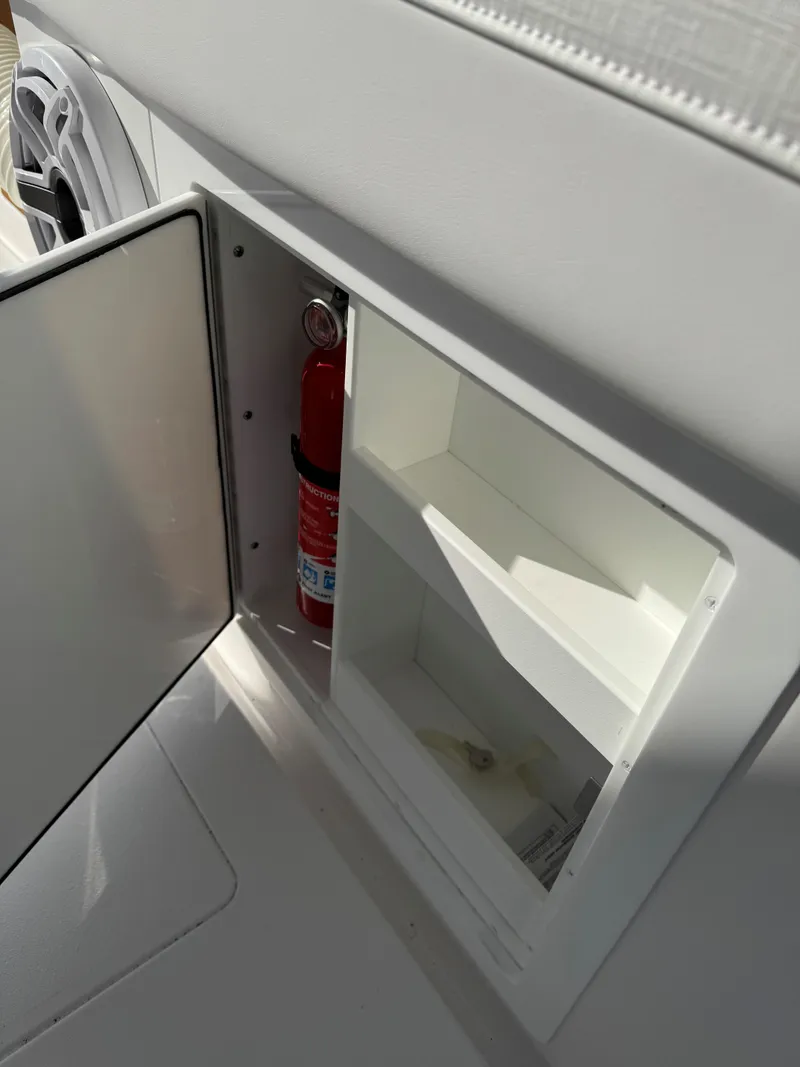 Slide: The Image of 2025 Caymas 34 CT boat storage compartment with fire extinguisher. - 26