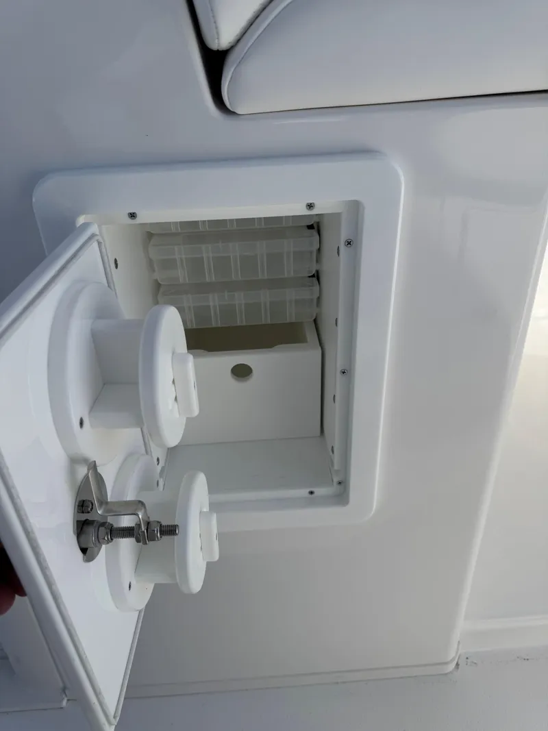 Slide: The Image of Open hatch on 2025 Caymas 34 CT boat, showing interior compartment. - 28