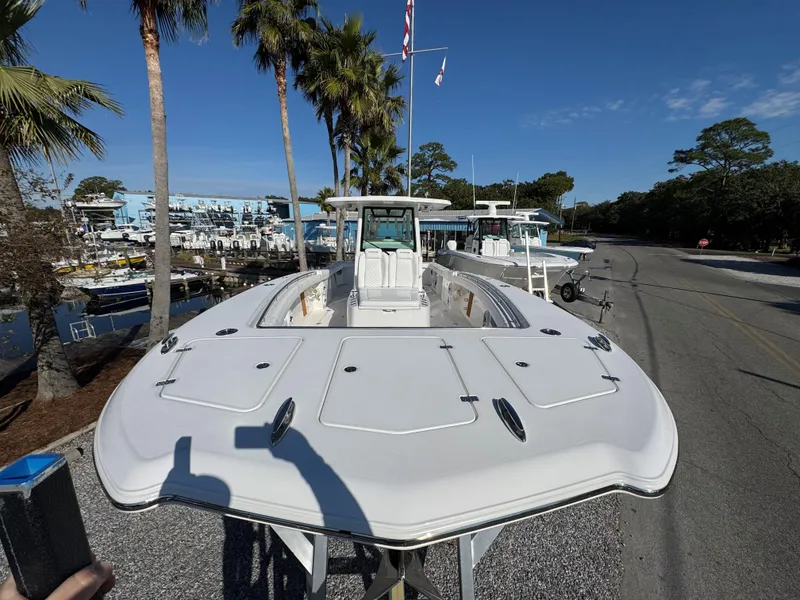 Slide: The Image of 2025 Caymas 34 CT boat docked near palm trees and marina. - 3