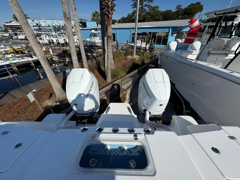 Slide: The Image of 2025 Caymas 34 CT boat with dual engines at a marina. - 8