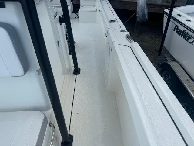 Slide: The Image of 2025 Parker 23SE Center Console boat interior, featuring sleek white deck and seating. - 11