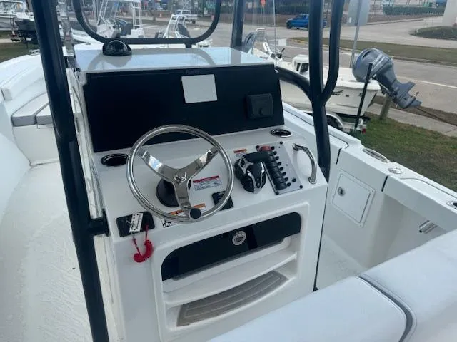 Slide: The Image of 2025 Parker 23SE Center Console boat interior with steering wheel and control panel. - 3