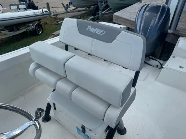 Slide: The Image of 2025 Parker 23SE Center Console boat seat with cushioned backrest and storage. - 4